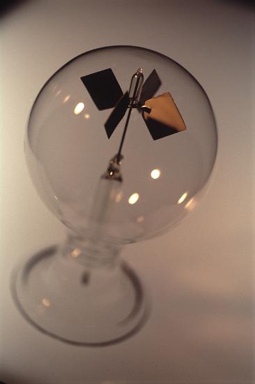a glass radiometer, this novely/curio object demeonstrates the energy contained in electromeganetic radioation (light) falling on the vanes in the centre of the globe.