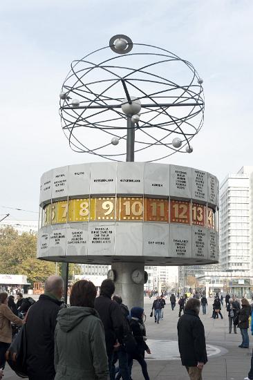 World Time Clock, Alexanderplatz, Berlin People viewing the World Time Clock, or Weltzeituhr, in Alexanderplatz, Berlin with the revolving planets above and the cylinder bearing 24 international time zones and names of major cities below