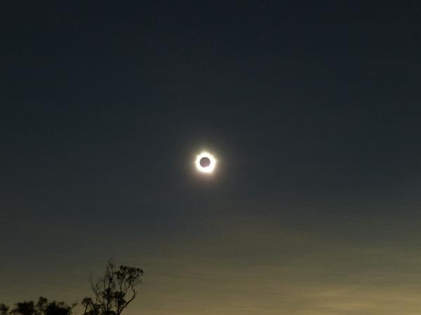 Solar eclipse with corona Solar eclipse with corona in a darkened sky as the moon passes between the sun and the earth obscuring the sun