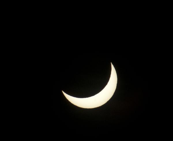 partial solar eclipse crescent sun before an eclipse, with sunspots visible