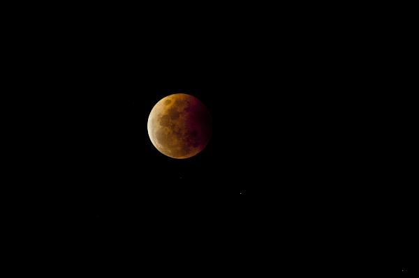 Red moon effect in dark sky Red moon or bloody moon astronomical effect in dark night sky during lunar eclipse