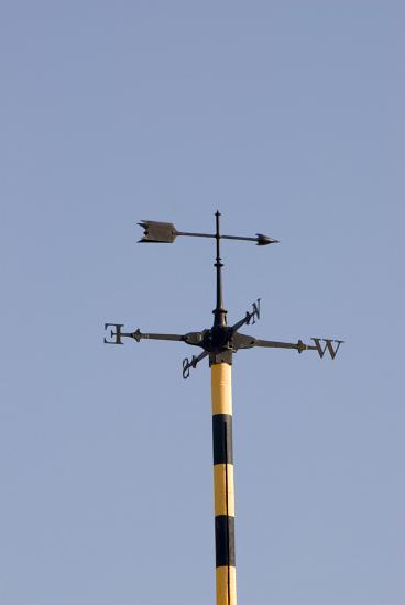 Weather vane Weather vane with an arrow showing the wind direction and the four points of the compass below against a clear blue sky, this vane was located at the top of an observatory after 1pm when the time ball had fallen to the bottom of the mast