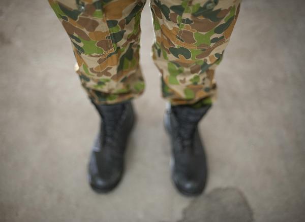 Camouflage Pants looking down at a soldier wearing army green camoflage pants, the disruptive pattern material is special designed to blend in with a range of background terrains and prevent the solder from being detected