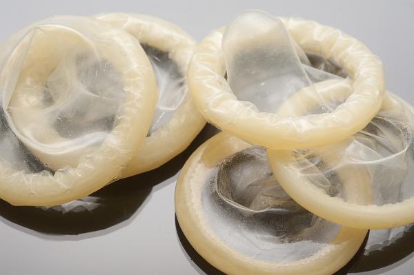 Pile of unused condoms Pile of plain latex unused condoms for practising safe sex preventing the spread of sexually transmitted disease and pregnancy