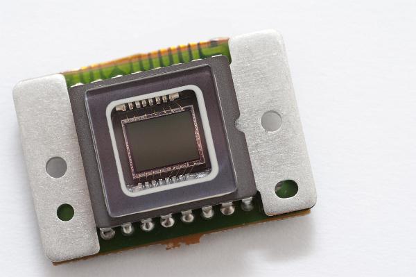 camera sensor chip macro image of the sensor chip from a CCD camera, tiny gold wires connect the silicone die to the pins on the edge of the device