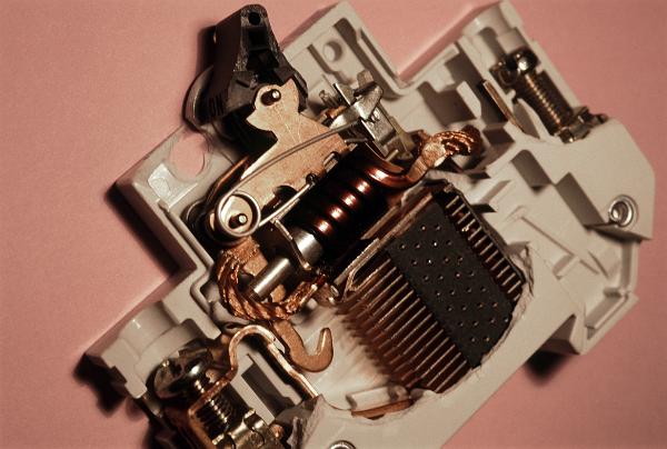 Electric circuit breaker Internal components of an electric circuit breaker designed to trip and interrupt the circuit in times of overload