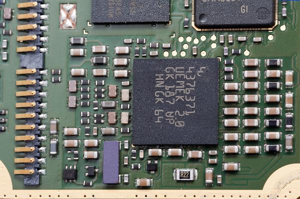 smt electronic components surface mounted electornic components including a BGA integrated circuit - the large black commonent in the centre alond with rows of passive descrete components
