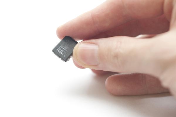 Small Chip in Fingertips Small Chip in Fingertips on white background. this chip was used to store firmware an embeddeed computer application
