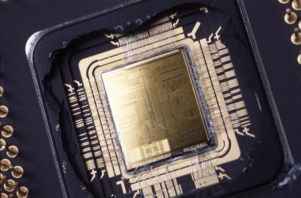 microprocessor macro A cut open view of the silicon wafer of a microprocessor showing the gas etched die surface and connecting wired (damaged in the opening process)