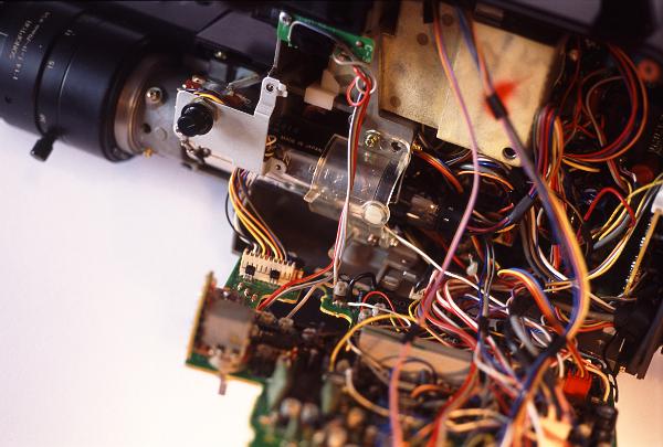 80's video camera electronics manufactured before the common use of printed flexible wiring and surface mount devices often contained many loomed connecting wires criss crossing between various circitboards within the device