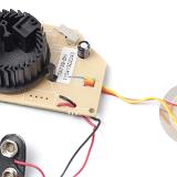 component parts of a domestic smoke detector showing the sensor chamber with lid removed, battery connector below and piezo sounder to the right