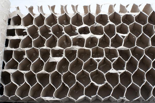 cardboard matrix cardboard interior of an internal door, the hollow honeycomb structure reinforces the door, when glued to panel on either side creates a strong ridget structure