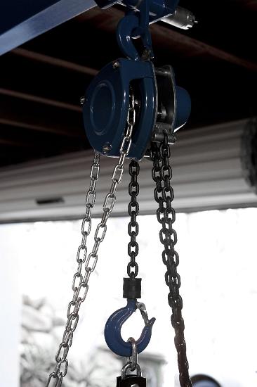 Mechanical Advantage - lifting blaok and tackle Heavy duty lifting block and tackle mounted to a roof and fitted with a large hook and chain