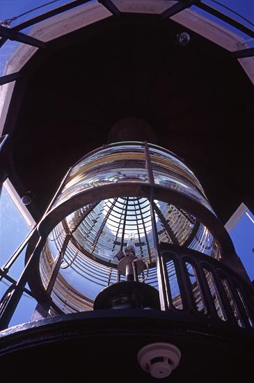 lighthouse lens a low angle view of the complex lens and lighting system in a lighthouse lantern room.