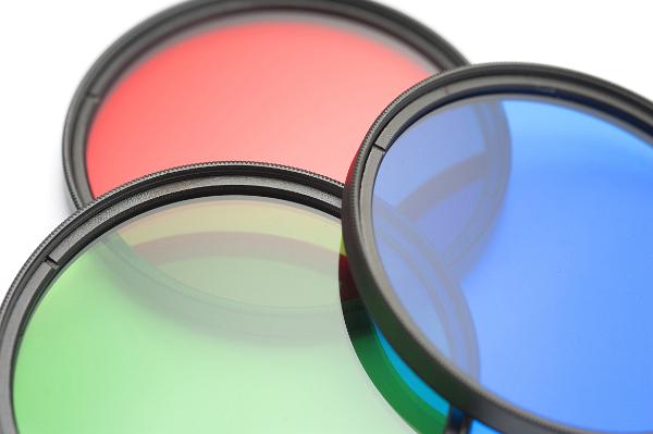 Set of filters showing the primary colors Set of circular filters showing the primary colors red, green and blue arranged to overlap on a white background, close up view