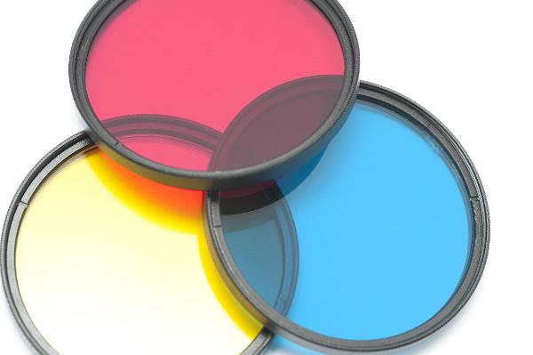 Yellow, cyan and magenta primary filters Yellow, cyan and magenta primary round optical filters overlapping on a white background to generate further colors